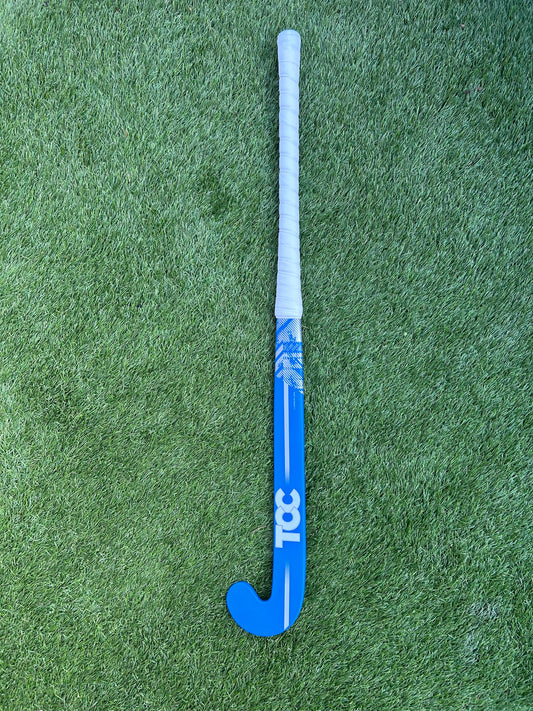 TCC Blue and white T1 hockey stick on a green grass field