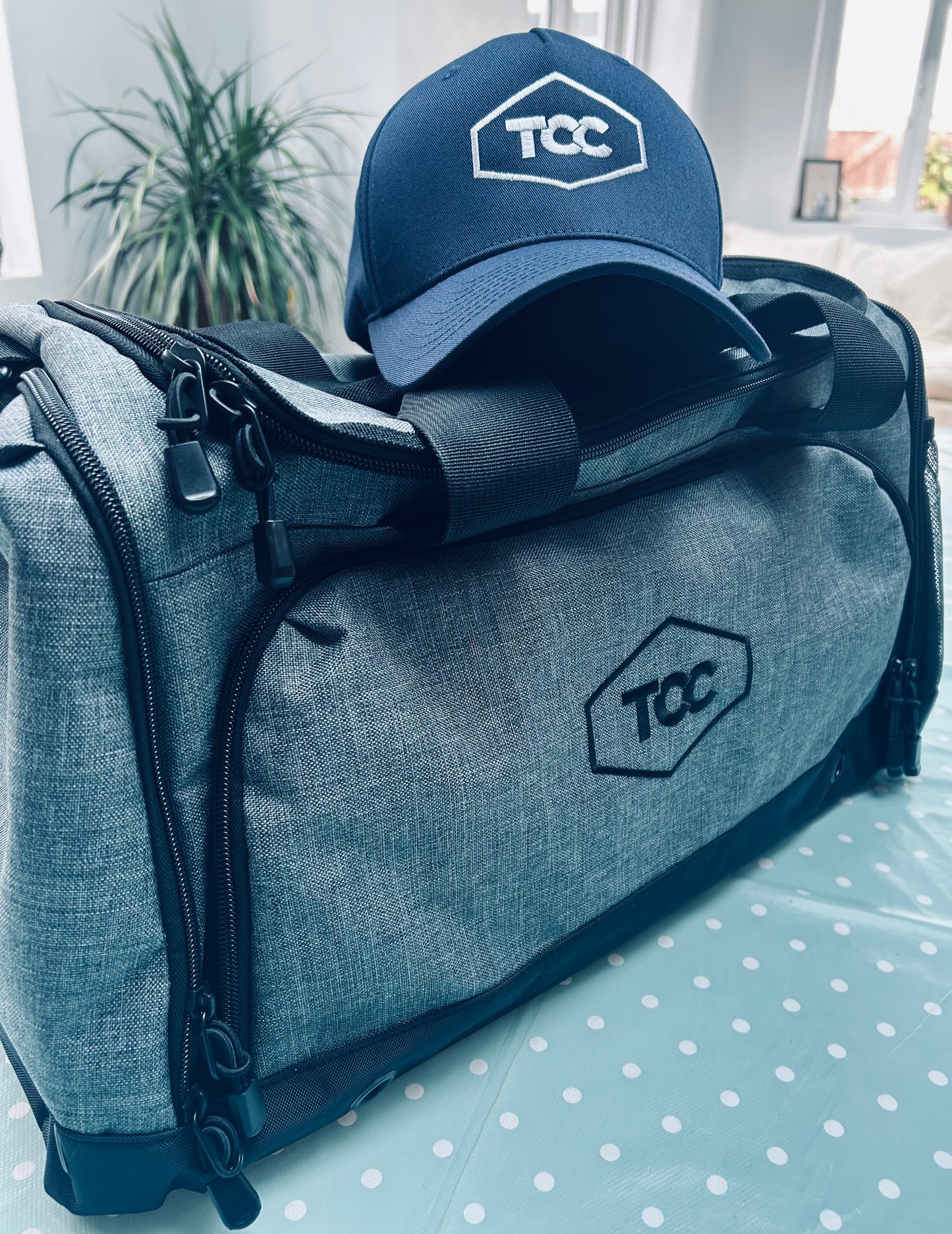 TCC Sports Holdall Grey Marl with TCC Flexi fit cap in Navy pictured inside