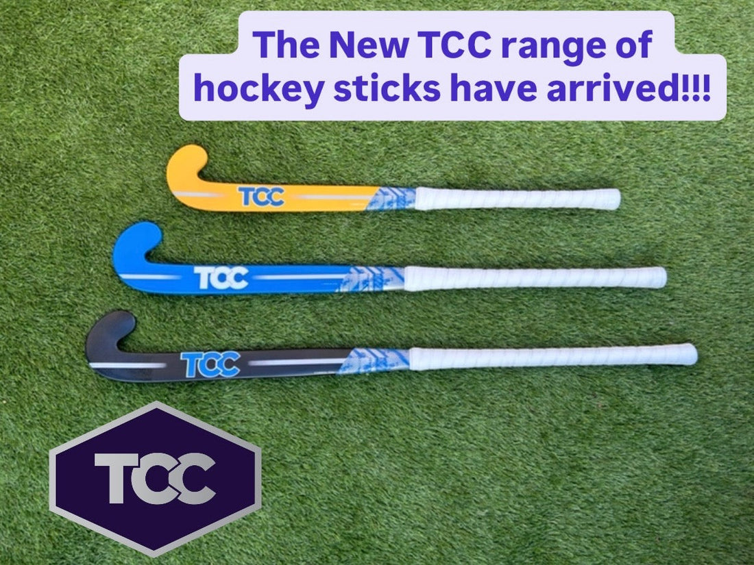 TCC Hockey stick range with yellow, blue and black sticks designed with the TCC logo on the grass