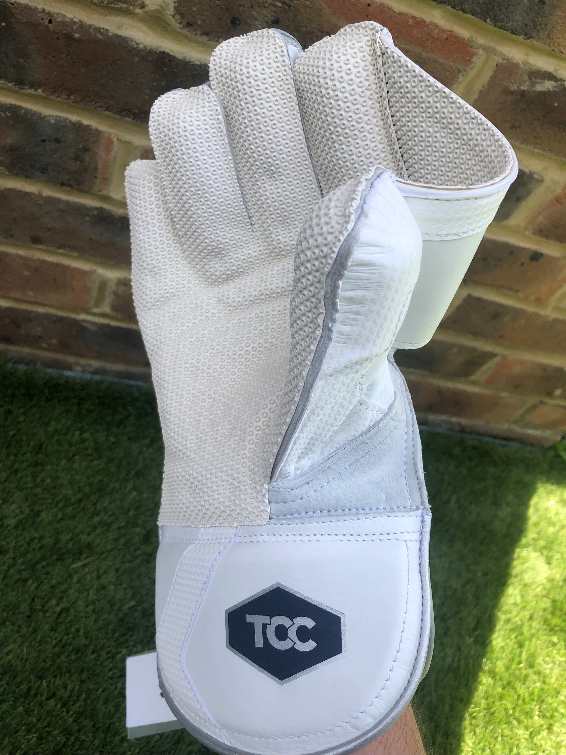 TCC Wicket Keeping Glove on right hand featuring the octopus grip and TCC logo on the wrist