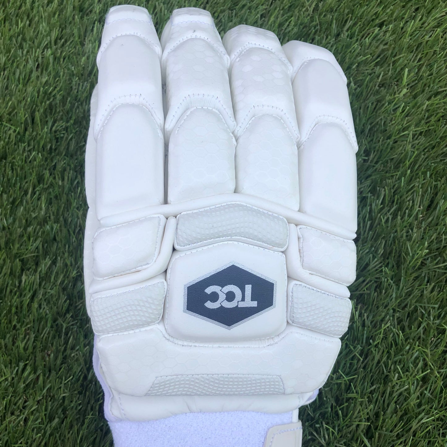 Focus on the back of the TCC premium batting glove with the logo and enhanced finger protection