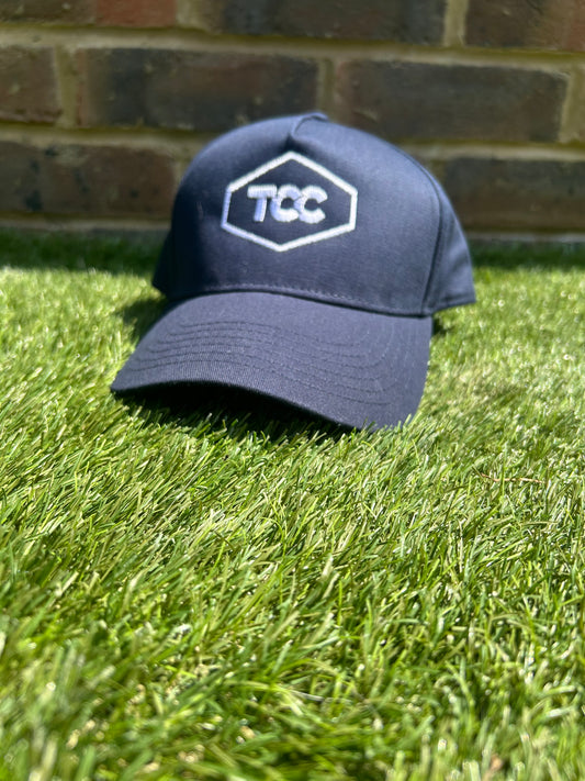 TCC Navy Adjustable Cap front on view positioned on the grass