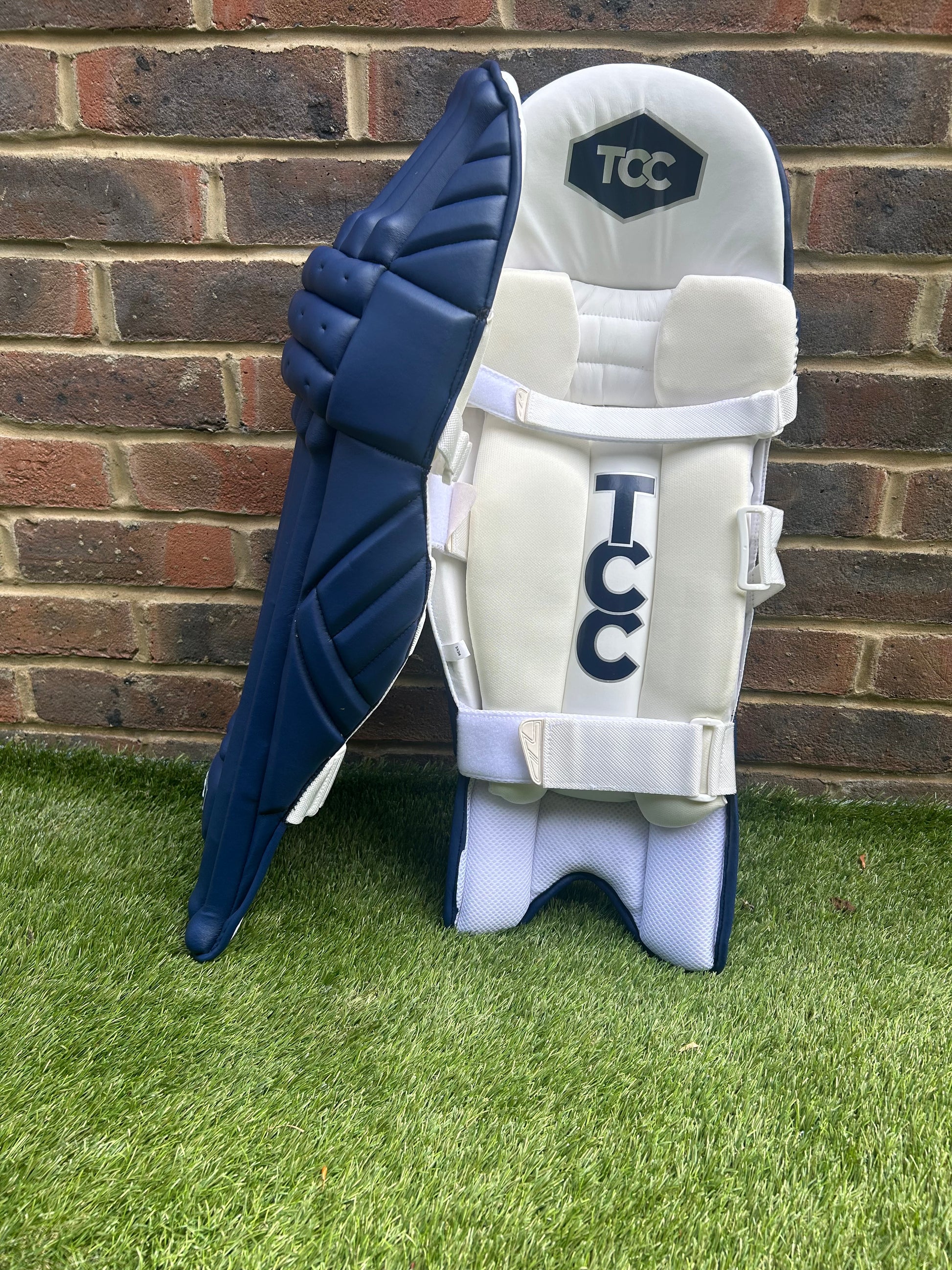 TCC Premium Navy Batting Pads with Navy Logo with side on profile view of these lightweight batting pads.