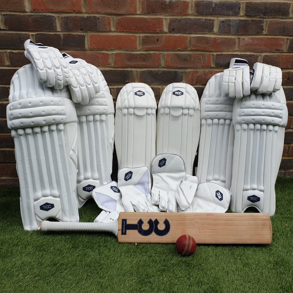 The TCC collection including cricket bat, pads and gloves